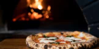 pizza on brown wooden table